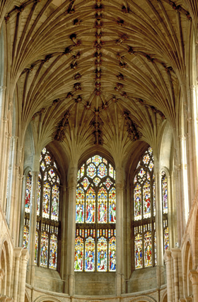 Bosses and stained glass windows in the vault of Norwich Cathedral