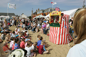 Punch and Judy show on the beach during the Old Leigh Regatta